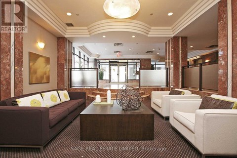 A living room with a brown couch and a white couch.