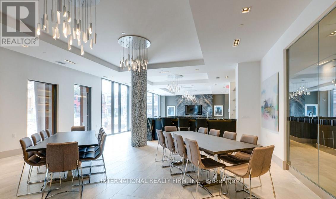 A modern dining room with a glass table and chairs.