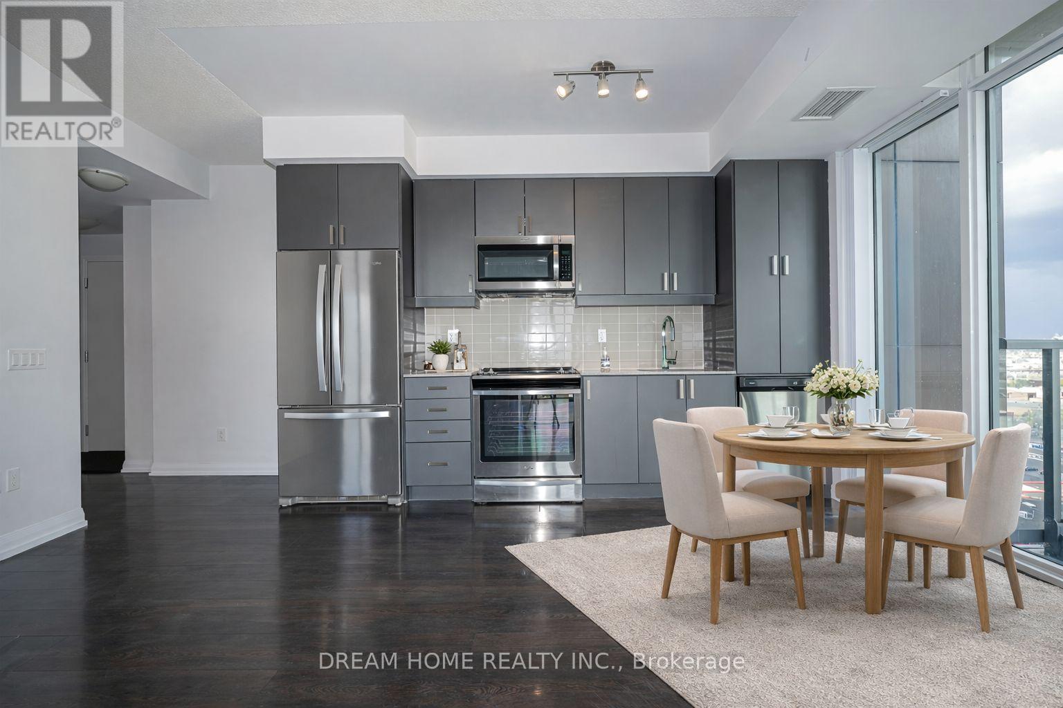 A modern kitchen with a dining table set for two.