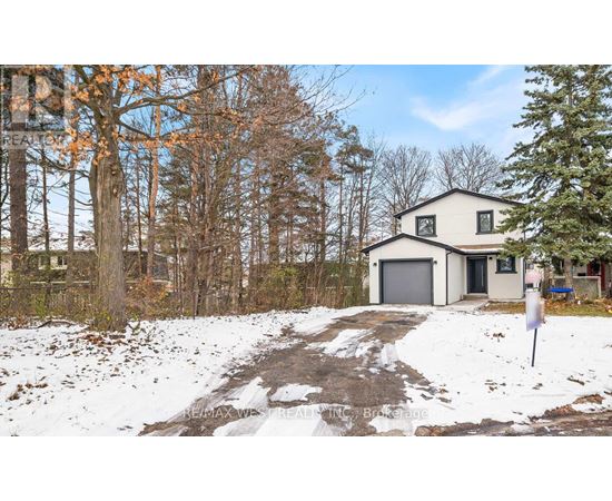 A house with a snow-covered driveway in front of it.