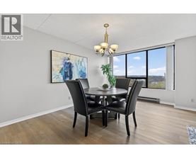 A dining room with a table set for four.