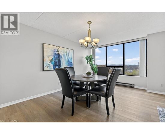 A dining room with a table set for four.