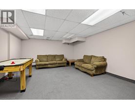 A room with a pool table and two couches.