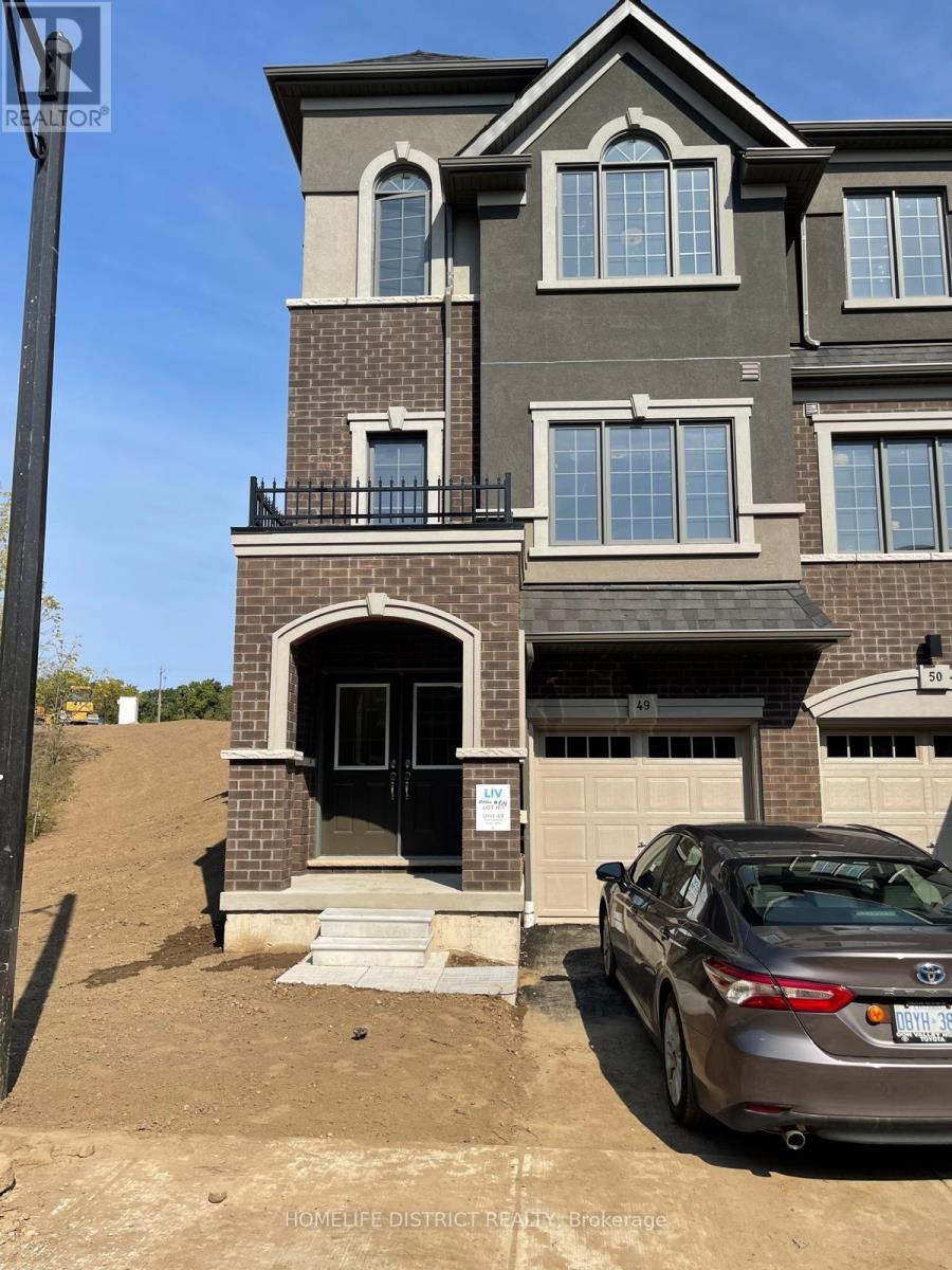 A car is parked in front of a two-story house.