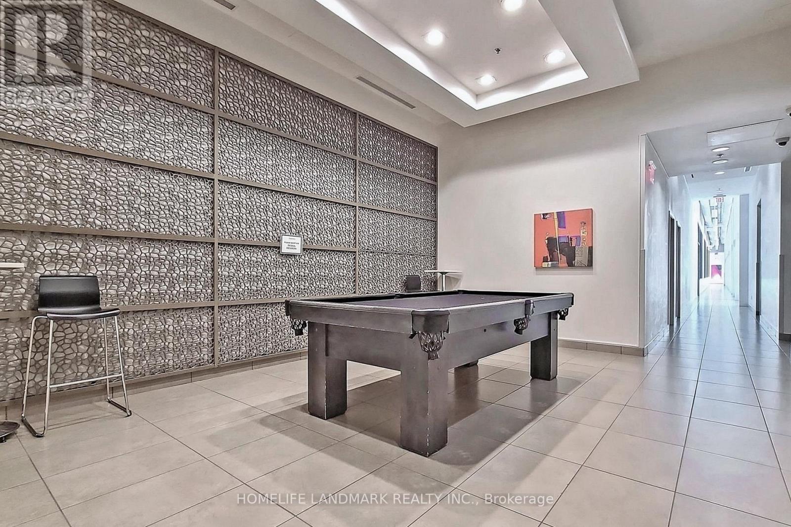 A room with a pool table and a chair.