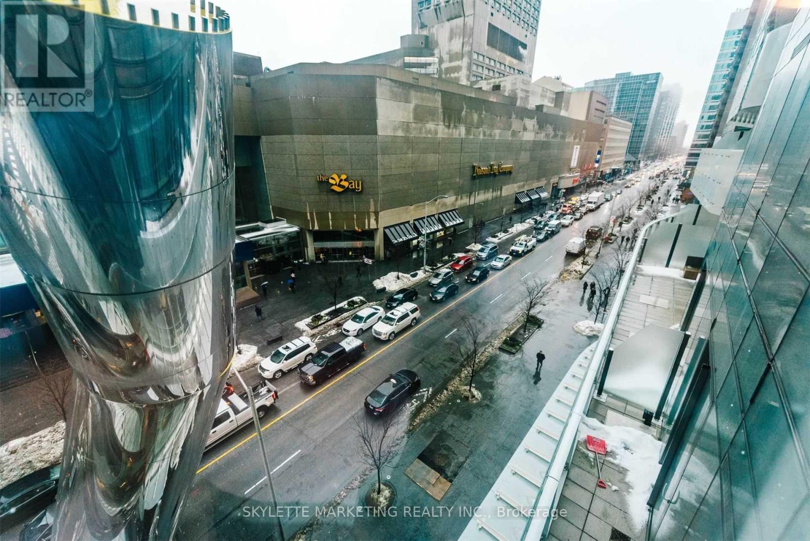 A city street with cars and buildings.