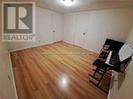 A room with a wooden floor and a piano.