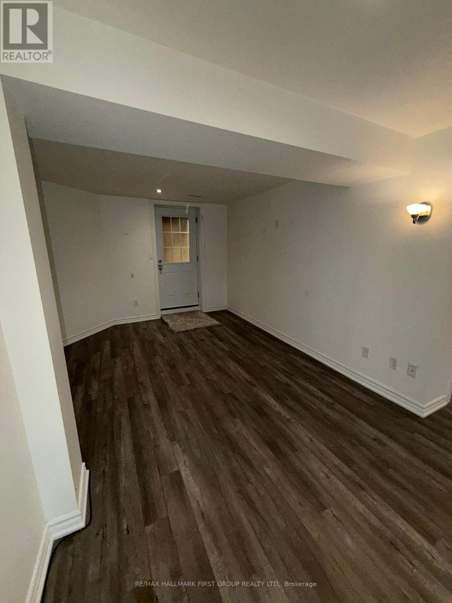 A room with a wooden floor and a white door.
