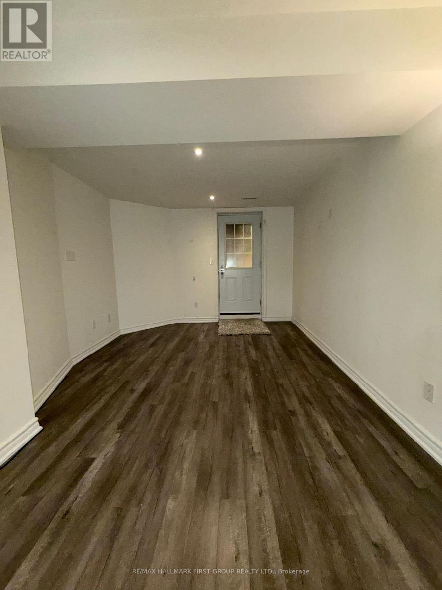 A room with wooden flooring and a white door.
