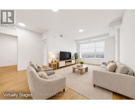 A living room with a couch, chair, and television.
