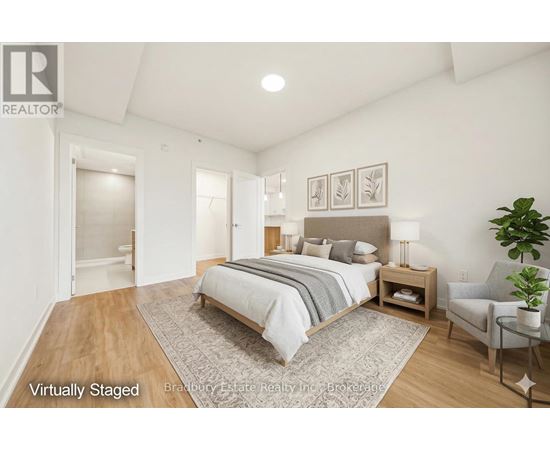 A bedroom with a bed, nightstand, and chair.