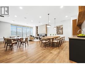 A modern dining room with wooden floors and furniture.
