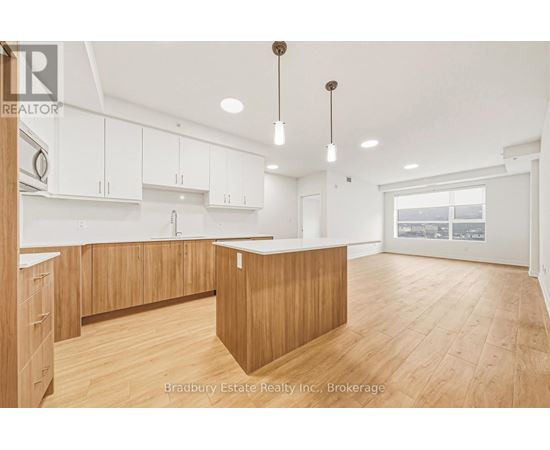 A spacious kitchen with wooden cabinets and a large island.
