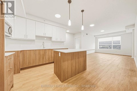 A spacious kitchen with wooden cabinets and a large island.
