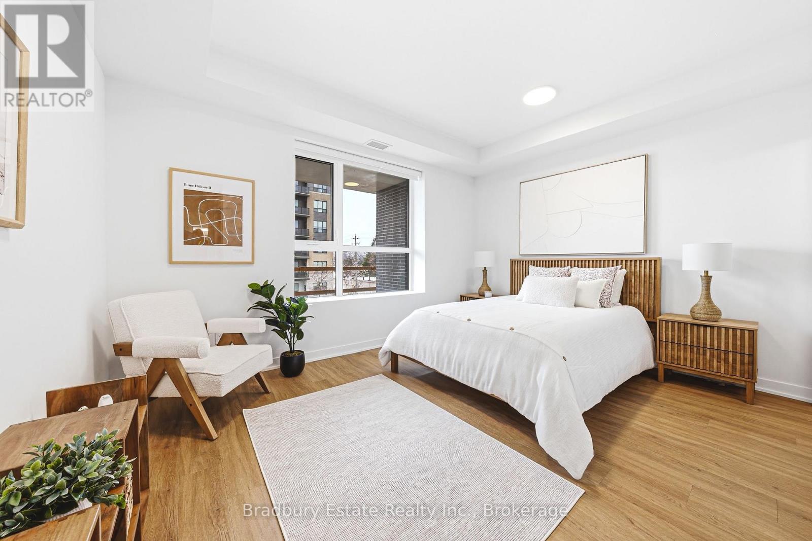 A bedroom with a bed, chair, and a potted plant.