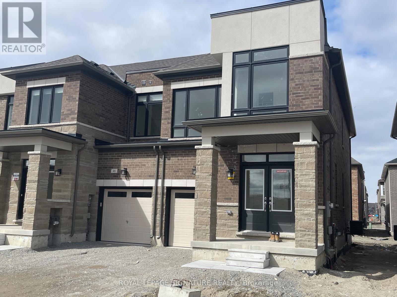 A modern two-story house with a garage is for sale.