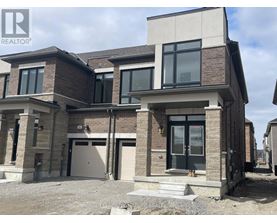 A modern two-story house with a garage is for sale.
