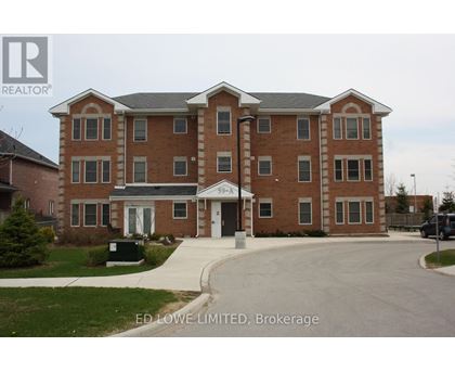 A large brick building with a white entrance and a sign that says "ED Lowe LIMITED, Brokerage".