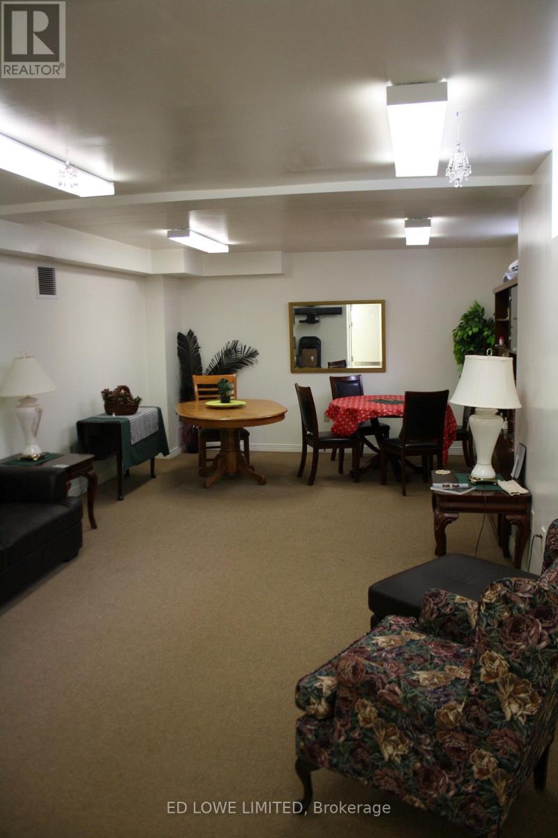 A living room with a couch, chair, and lamp.