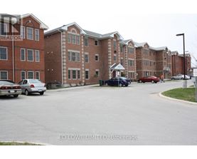 A parking lot with cars and apartment buildings in the background.