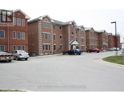 A parking lot with cars and apartment buildings in the background.
