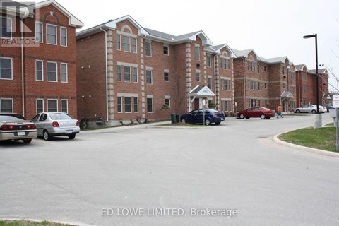 A parking lot with cars and apartment buildings in the background.
