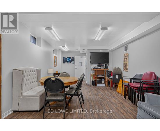 A living room with a dining table and chairs.
