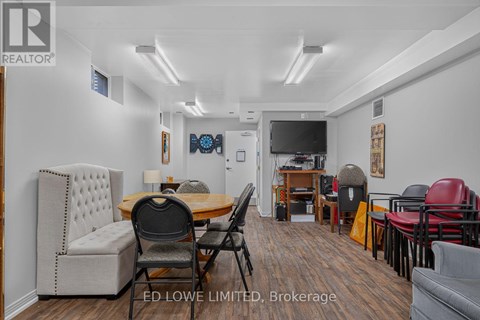 A living room with a dining table and chairs.
