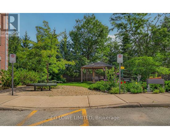 A park with a gazebo, bench, and trees.