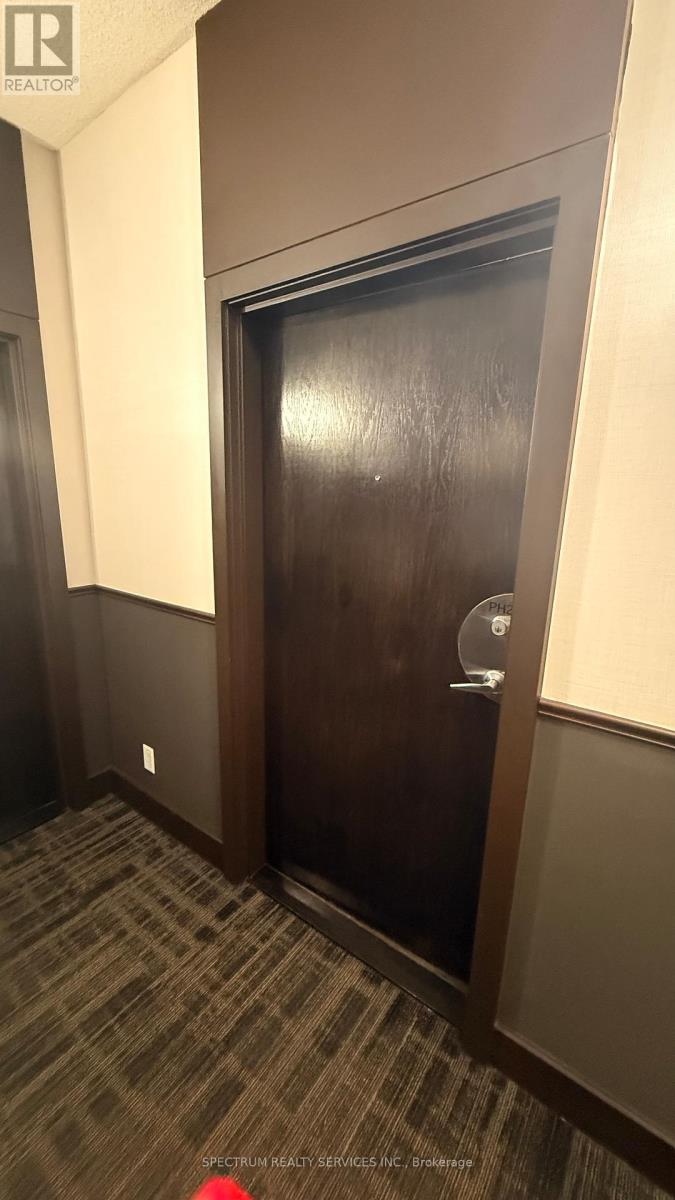 A brown door with a glass window and a handle.