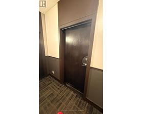 A brown door with a glass window and a handle.