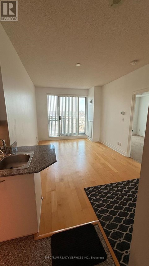 A kitchen with a sink and a window.
