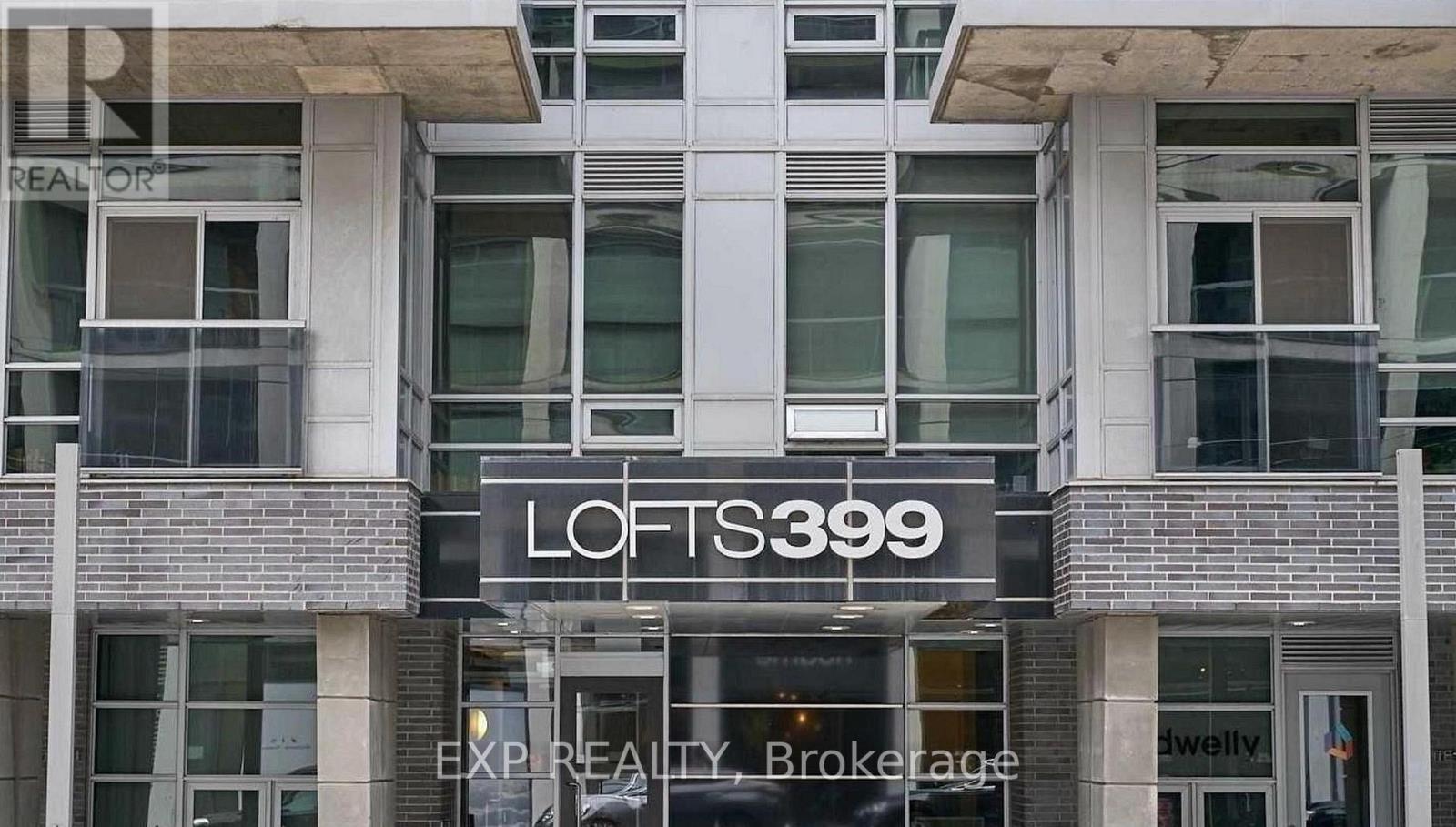 A building with a sign that says "LOFTS 3399" in front of it.