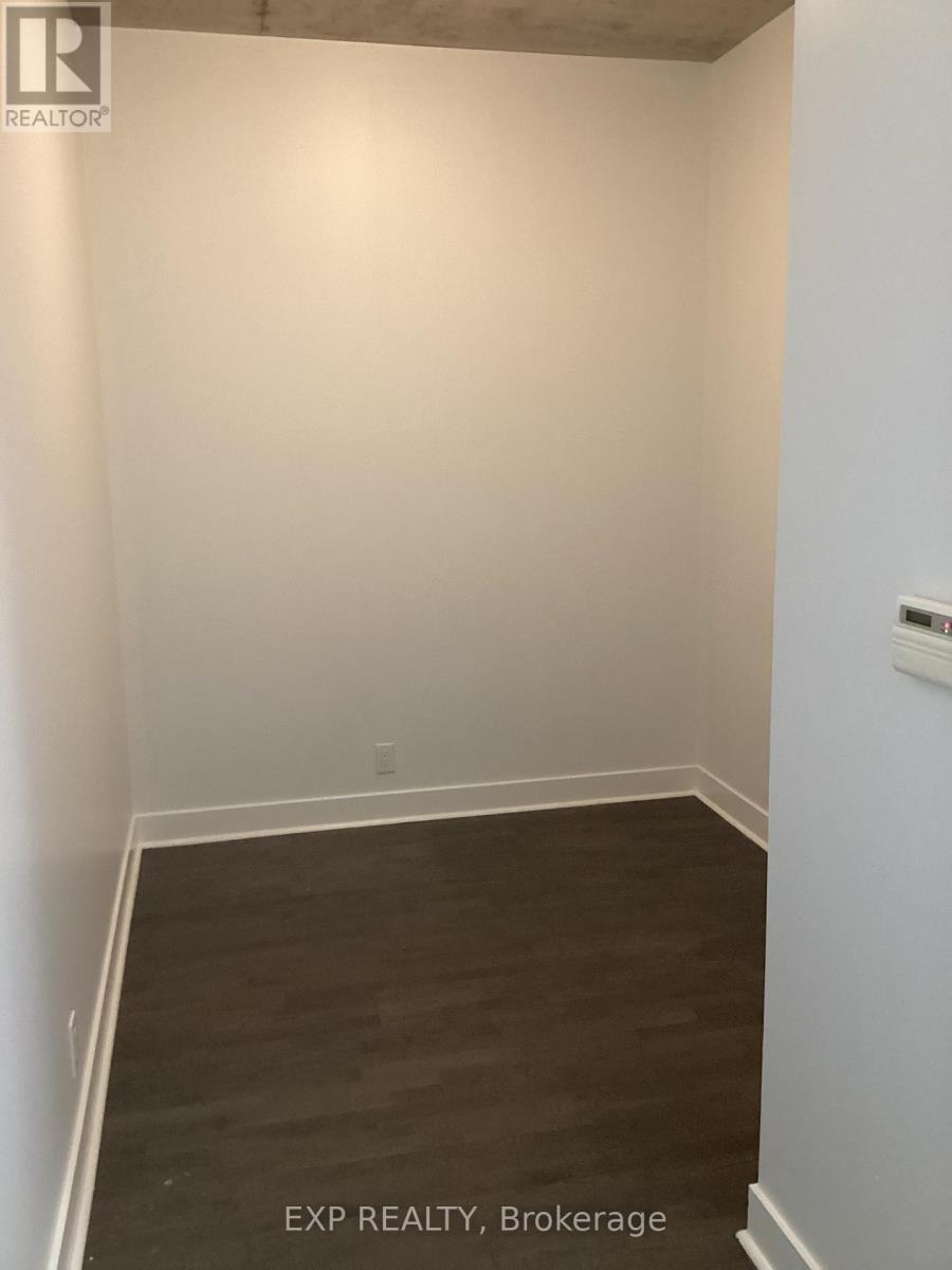 A room with white walls and a wooden floor.