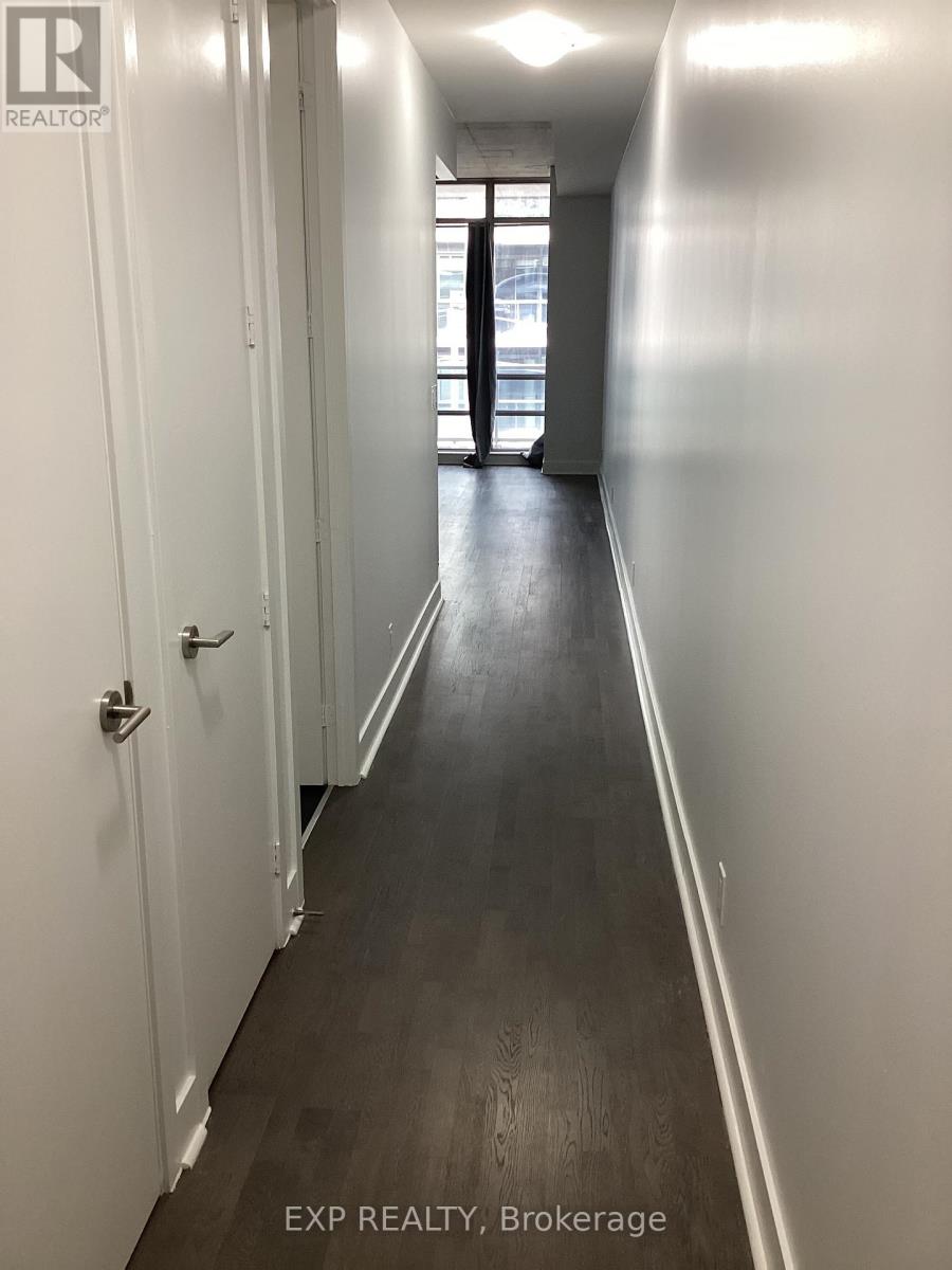 A long hallway with doors on both sides.