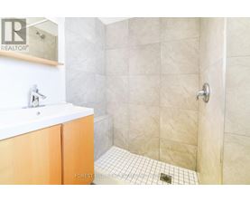 A bathroom with a white sink and a tiled floor.