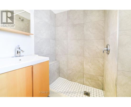 A bathroom with a white sink and a tiled floor.