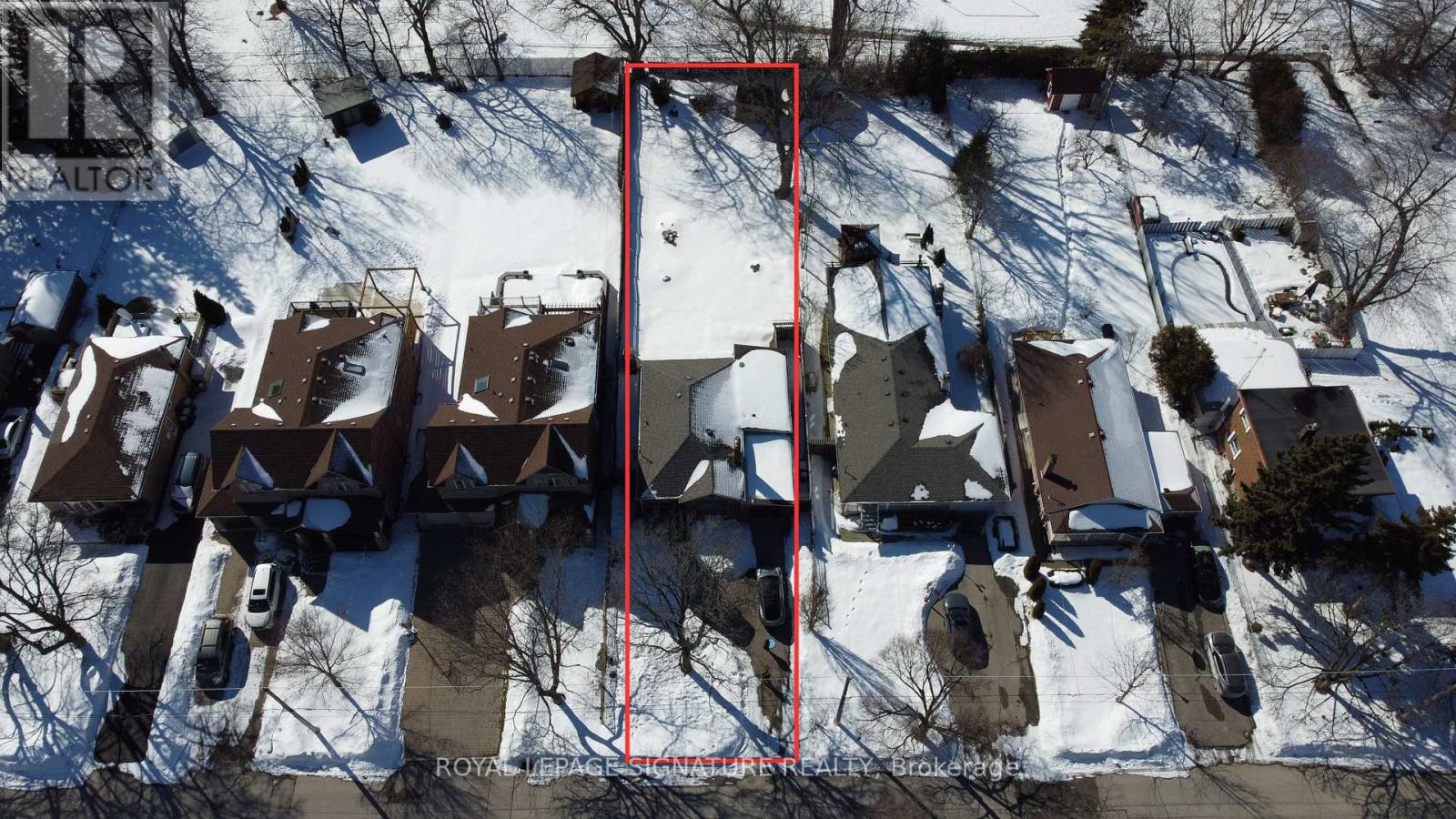 A red square is drawn on a snowy residential area.