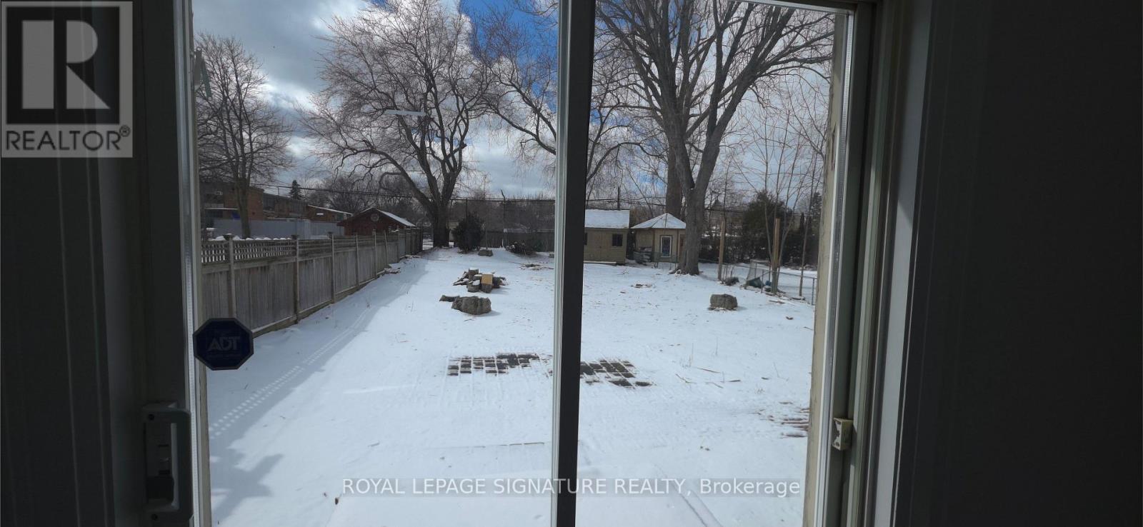 A view from inside a building looking out to a snowy landscape.