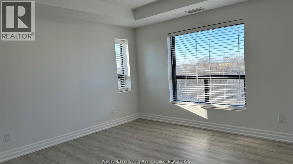 A room with a window and a wall-mounted air conditioner unit.