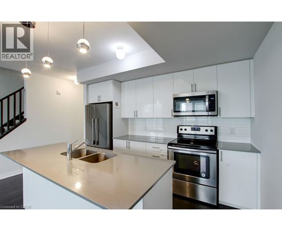 A modern kitchen with a stainless steel oven and microwave.
