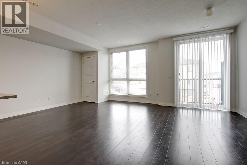 A spacious room with wooden floors and white walls.