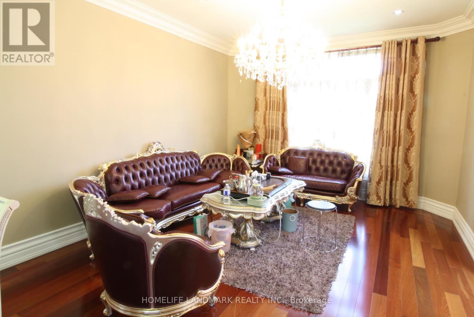 A living room with a brown leather sofa and a matching armchair.