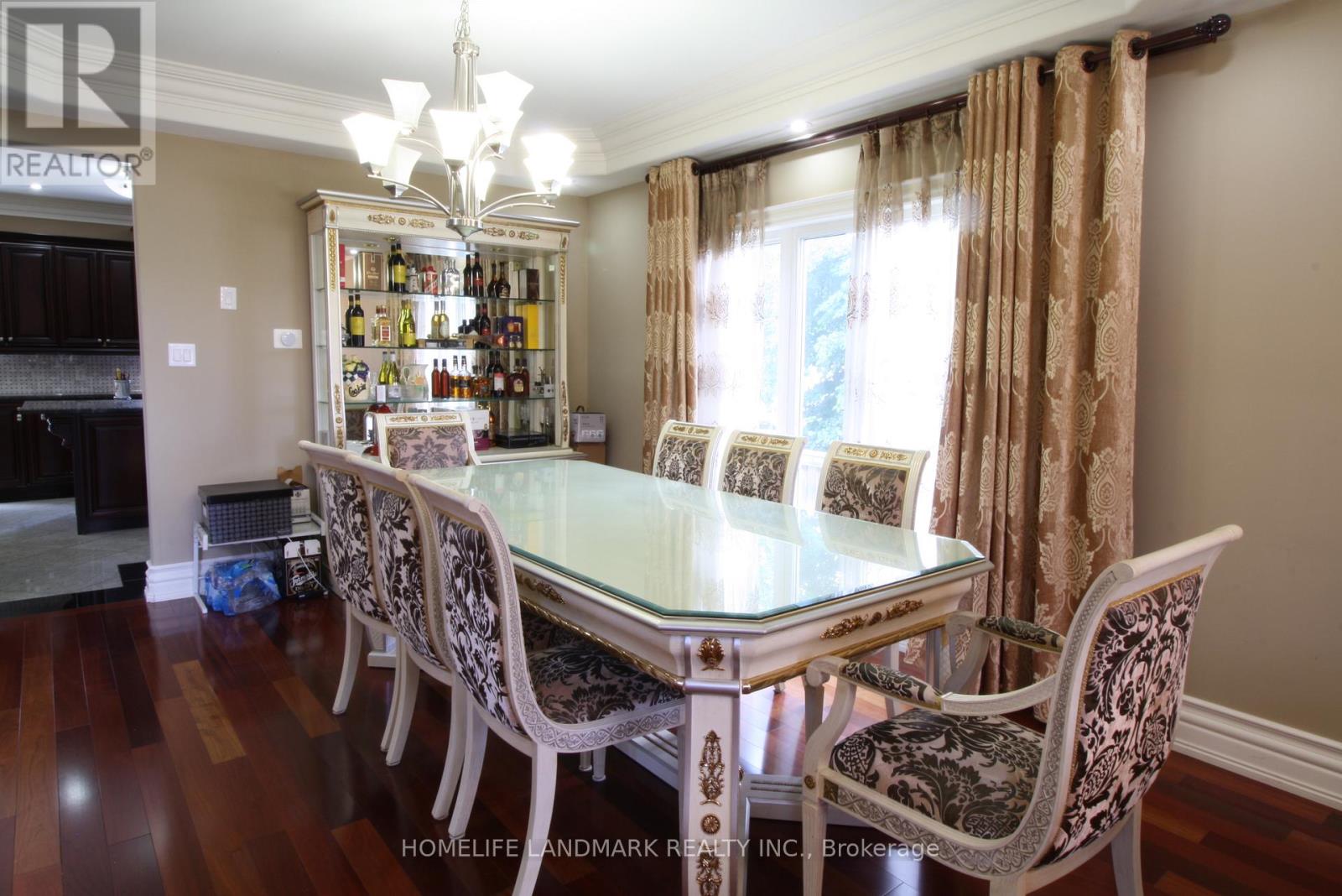 A dining room with a glass table and chairs.