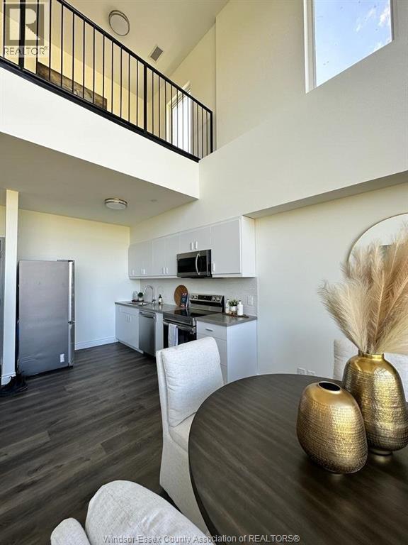 A modern kitchen with a dining table and chairs.