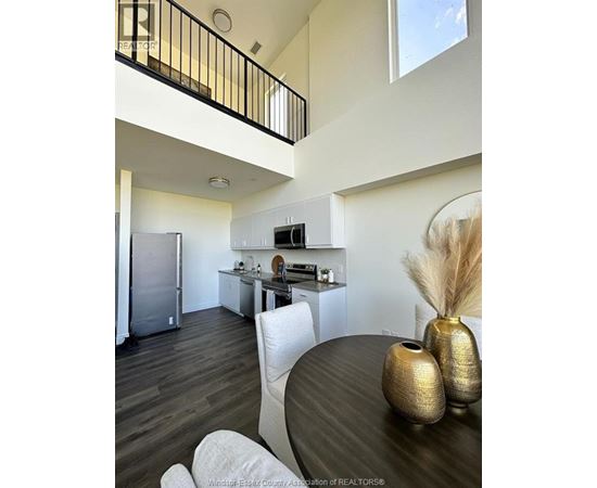 A modern kitchen with a dining table and chairs.