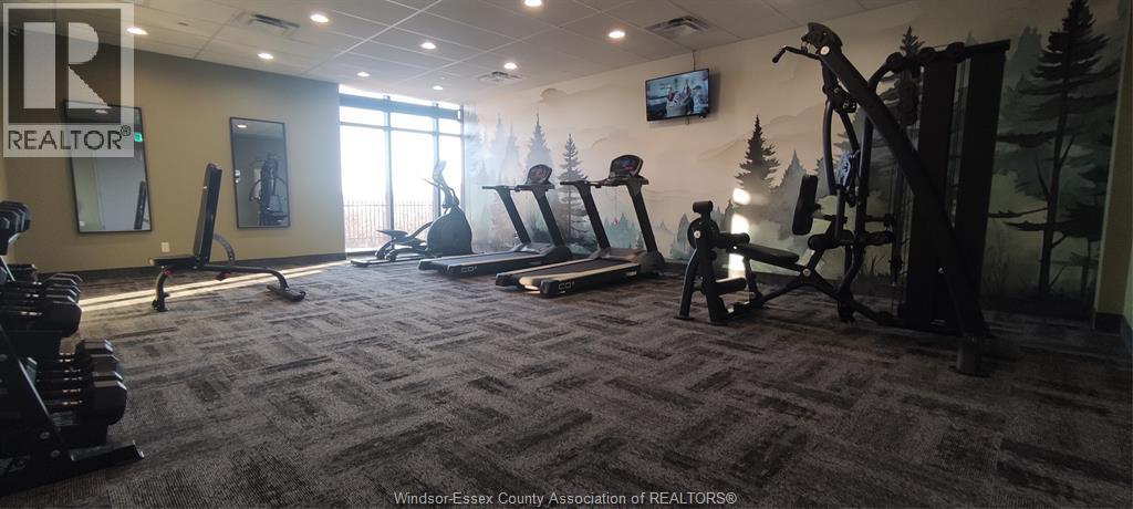 A gym with a variety of equipment including treadmills, weights, and exercise machines.