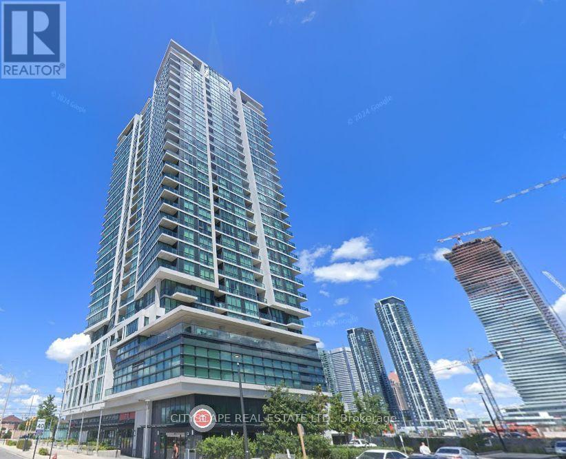 A tall building with a glass facade is the main focus of the image.