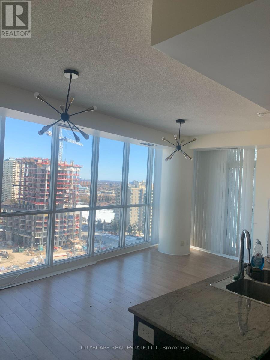 A real estate listing photo of a kitchen with a marble counter top.