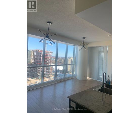 A real estate listing photo of a kitchen with a marble counter top.